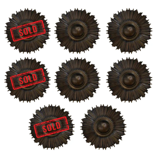 Set of eight bronze sunburst wall art pieces with 'SOLD' stamp on a white background