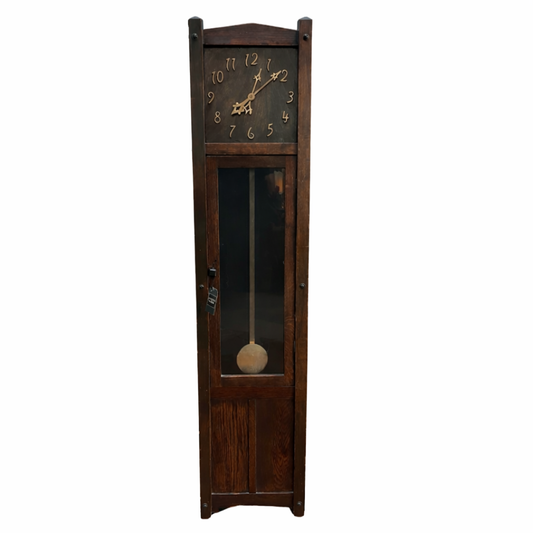 Wooden grandfather clock with a visible pendulum on a white background